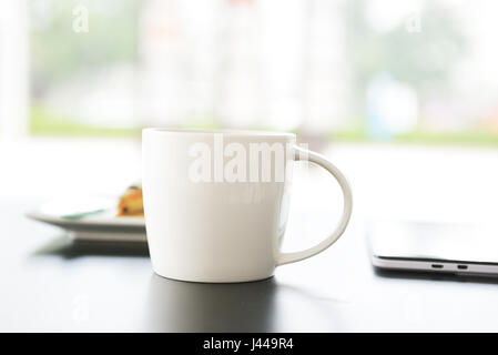 Tablets and close-ups of coffee cup on the table Stock Photo
