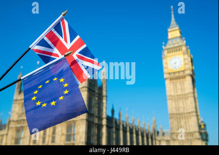 EU European Union and UK Union Jack flags flying together in optimistic solidarity on the London skyline in front of the Houses of Parliament Stock Photo