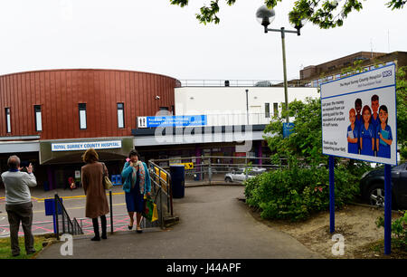 General view of facade of Royal Surrey County Hospital, with sign justifying its car parking charges, Guildford, Surrey, UK. Stock Photo