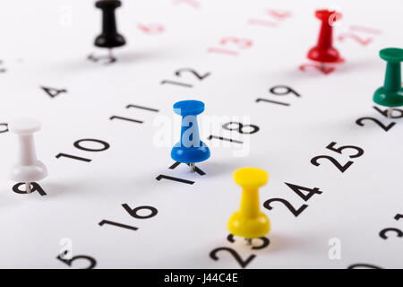 busy schedule - colorful pins on a calendar Stock Photo