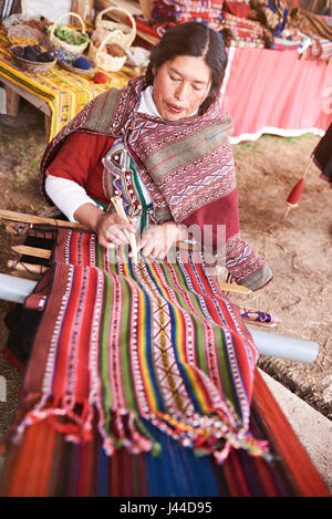 Cusco, Peru - April 21, 2017: Peruvian woman with inca wool. Local woman make traditional wool cloth Stock Photo