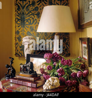 Antique tablecloth and wall panel with treasured objects Stock Photo