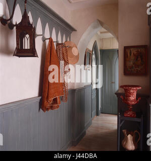 Gothic doors and archways with tongue and groove panelling in narrow hallway Stock Photo