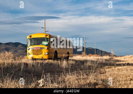 Vintage school bus abandoned in a field in Utah. Stock Photo