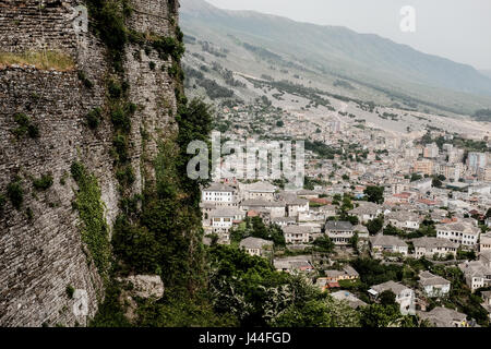 A view of the town of Gjirokaster, a city inscribed in the UNESCO World Heritage List, from the dominating Gjirokaster Castle. Albania has a population of just over 3 million, only one third of all Albanians in the world due to negative migration. Close to 60% of the population are Muslim, close to 20% unemployed and 15% below the poverty line. The transition from Communism which began in the 1990's has proven challenging due to high unemployment, widespread corruption, dilapidated infrastructure and powerful organized crime networks. The country is still one of the poorest in Europe. Stock Photo