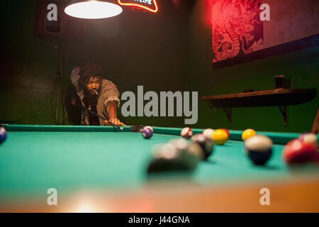 A young man playing pool. Stock Photo