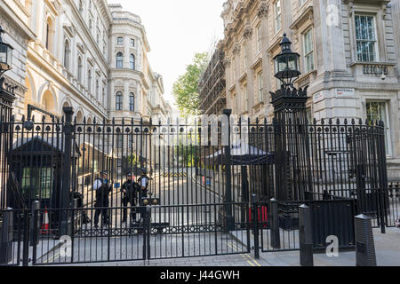 Exterior view of the entrance to Downing Street showing the police armed guard and security gates, during the daytime. Stock Photo