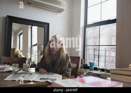 A young man reading the newspaper Stock Photo
