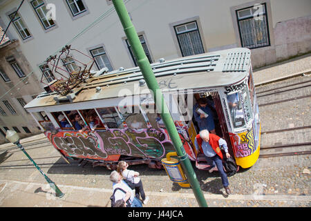 Portugal, Estremadura, Lisbon, Bairro Alto, Elevador da Gloria, Funicular railway tram covered in graffiti. Stock Photo