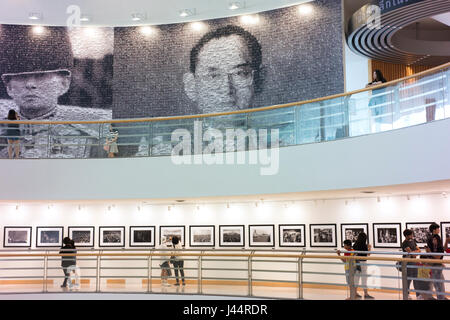 Visitors view photos of and by the late King Bhumibol Adulyadej of Thailand in the Bangkok Art and Culture Centre. Stock Photo