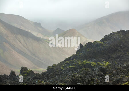 The view into a cloud covered valley of Rhyolite mountains in the Icelandic highlands Stock Photo