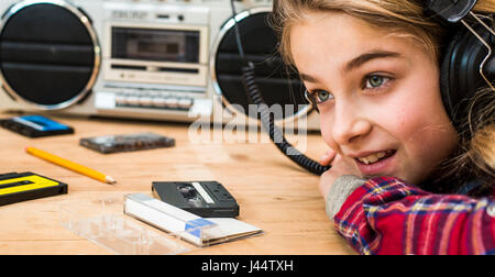 Retro styled image with girl using boombox Stock Photo