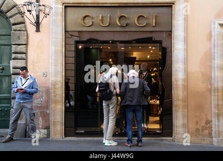 Two men look into the shop window of luxury fashion brand Gucci on 02 may 2017 in Rome, Italy Stock Photo