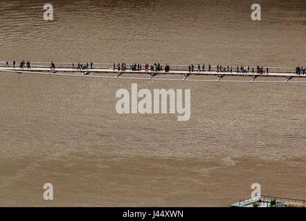 the London Millennium Footbridge Pedestrians on the footbridge over the river Thames in central London Stock Photo