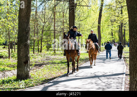 Samara, Russia - May 7, 2017: Female mounted police on horse back in the city park Stock Photo
