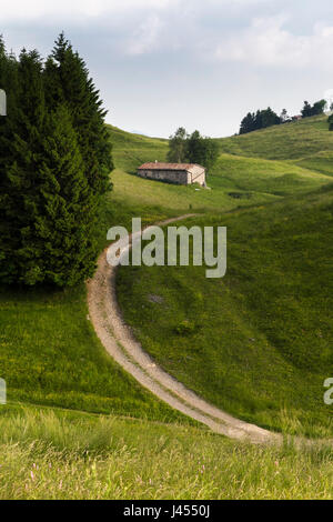 Trails on the green hills of Monte Farno in spring, Gandino, Valgandino, Val Seriana, Bergamo province, Lombardy, Italy. Stock Photo