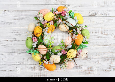 Decoration from easter eggs in shape of circle on painted wooden background Stock Photo