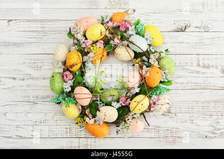 Decoration from easter eggs in shape of circle on painted wooden background Stock Photo