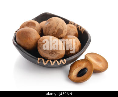 Whole and partial fresh sapodilla in bowl isolated on white background Stock Photo