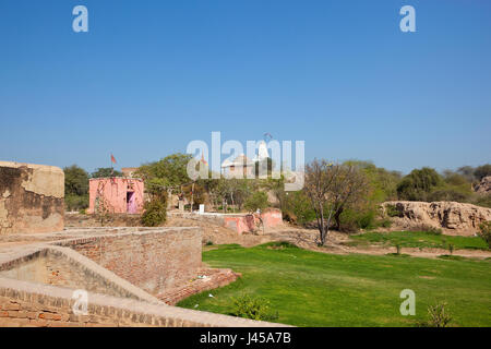 the top of bhatner fort with a hindu temple and grounds currently under restoration work in the city of hanumangarh rajasthan india under a blue sky i Stock Photo