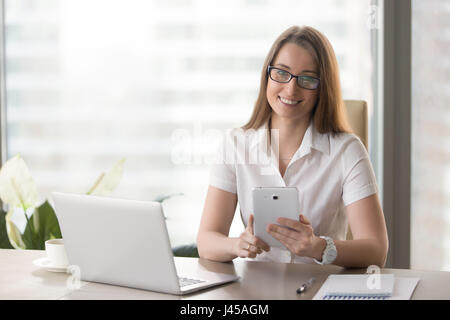 Female entrepreneur using digital tablet in office Stock Photo