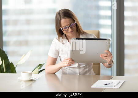 Stressed female hates her old lagging laptop Stock Photo