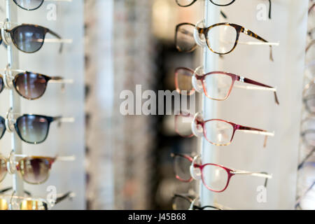 Many different glasses displayed at optician in store with different frames Stock Photo