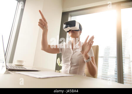 Business woman wearing virtual reality glasses Stock Photo