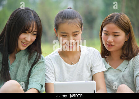 Three women together watching a tablet.Asian people Stock Photo