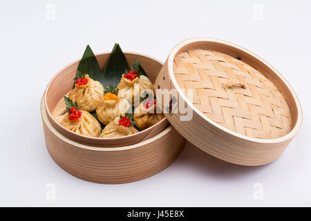Fresh and hot manti dumplings in bamboo steamer. isolated. Stock Photo