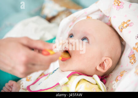 mother feeding baby baby food Stock Photo