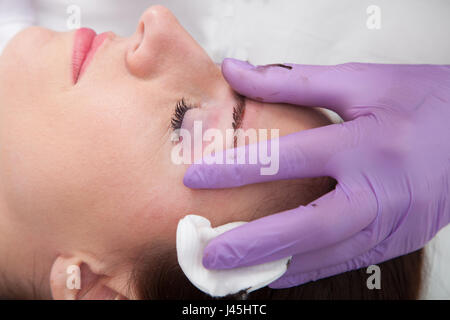 Cosmetologist applying permanent make up on eyebrows Stock Photo