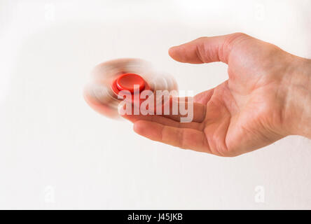 Hand spinner fidget finger toy spinning on a finger Stock Photo
