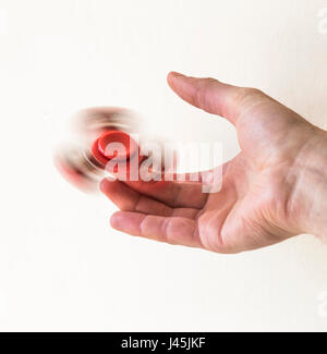 Hand spinner fidget finger toy spinning on a finger Stock Photo