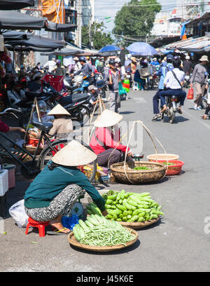 NHA TRANG, VIETNAM - JANUARY 20: Women are selling greens at the market street on January 20, 2016 in Nha Trang, Vietnam. Stock Photo