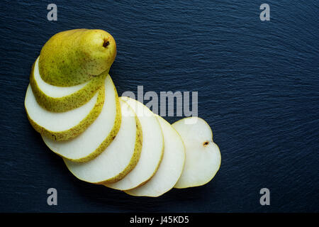 Ripe Pear on the dark slate background Stock Photo