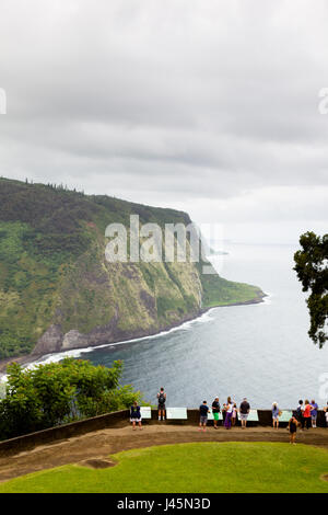 Tourists looking over Waipio Valley from the Waipio Valley Lookout on Big Island, Hawaii, USA. Stock Photo