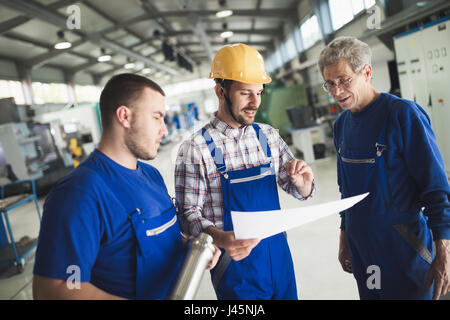 Mechanical and metal industry engineers working in factory Stock Photo