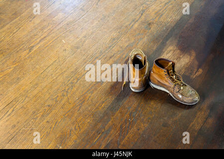Workman's leather boots on the floor. Stock Photo