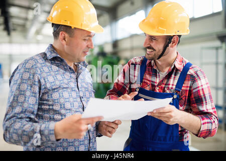 Industry Worker working on cnc machine in metal industry factory Stock Photo