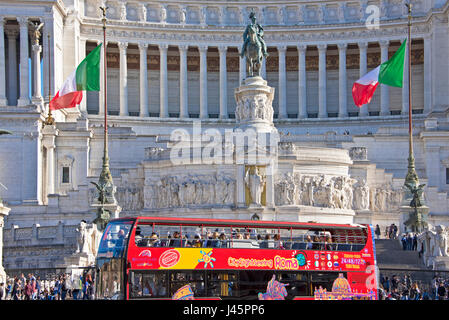 Altare della Patria or Monumento Nazionale in Rome Roma on a sunny day with blue sky and a tourist bus driving past. Stock Photo