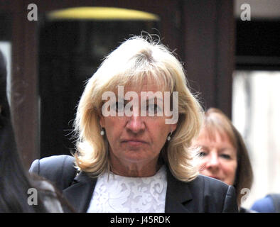Barbara Cooke, 57, leaves the Royal Courts of Justice in central London ...