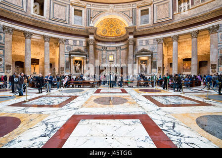 An interior view of tourists visitors visiting inside the Pantheon in Rome. Stock Photo