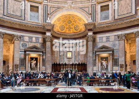 An interior view of tourists visitors visiting inside the Pantheon in Rome. Stock Photo