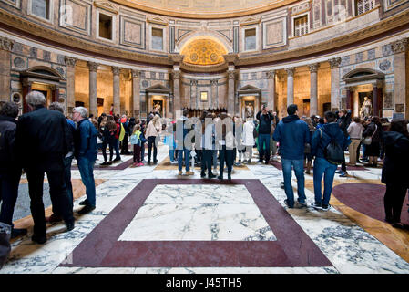 An interior view of tourists visitors visiting inside the Pantheon in Rome. Stock Photo