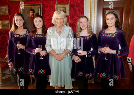 The Duchess of Cornwall (centre) meets the Tir na N-Og Irish Dancers, (left-right) Sarah White, Rose McAuley, Zoe McGarry, and Naomi Brown during a Music & Words for a Spring Evening at Hillsborough Castle during their visit to Northern Ireland. Stock Photo
