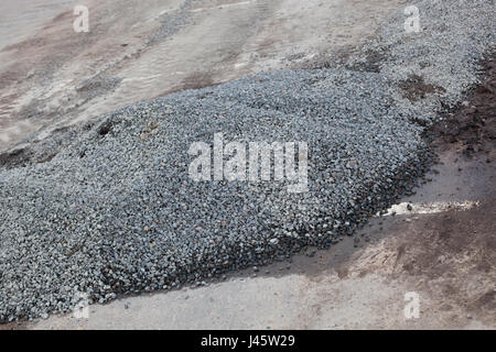 Cement and stones on the old road. Stock Photo