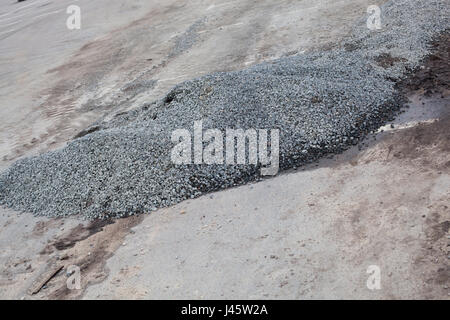 Cement and stones on the old road. Stock Photo