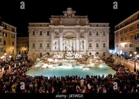 An aerial view of The Trevi Fountain 'Fontana di Trevi' in Rome with crowds of tourists and visitors at night. Stock Photo