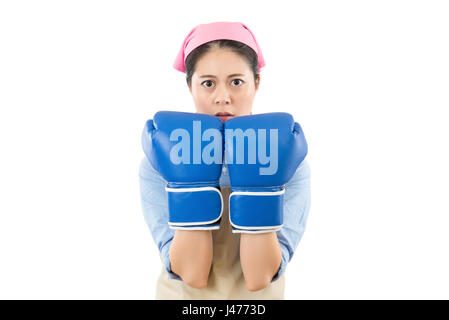 cleaning housewife wearing boxing gloves ready to fight. Strength power or competition concept image of beautiful young mixed race Chinese Asian woman Stock Photo